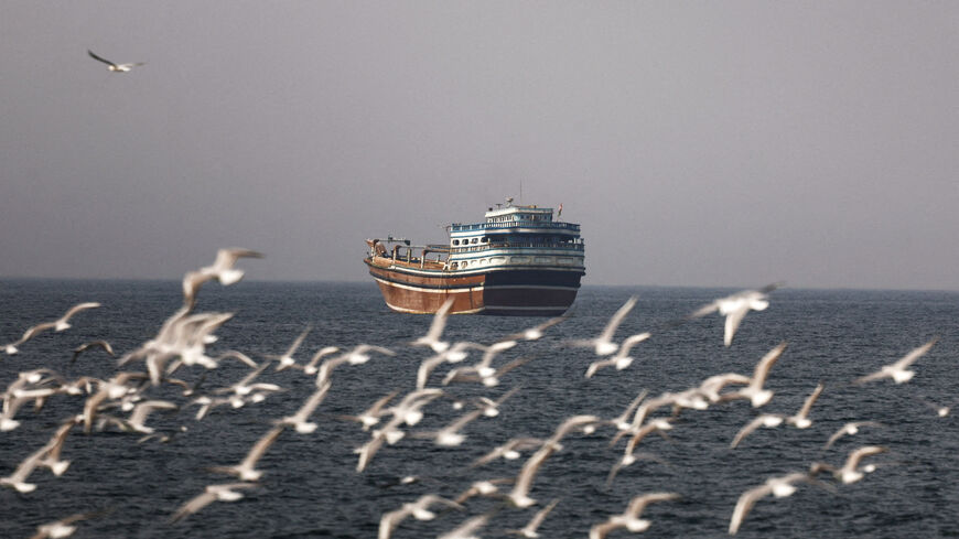 FILE PHOTO: Birds fly near a boat in the Strait of Hormuz amid the U.S.-Israeli conflict with Iran, as seen from Musandam, Oman, March 2, 2026.REUTERS/Amr Alfiky/File Photo