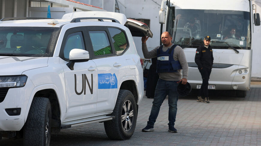 A UN worker looks on next to a vehicle as Palestinians get ready to leave Gaza through the Rafah border crossing between Gaza and Egypt, after it was opened by Israel on Thursday for a limited number of people, in Khan Younis in the southern Gaza Strip, March 19, 2026. REUTERS/Ramadan Abed
