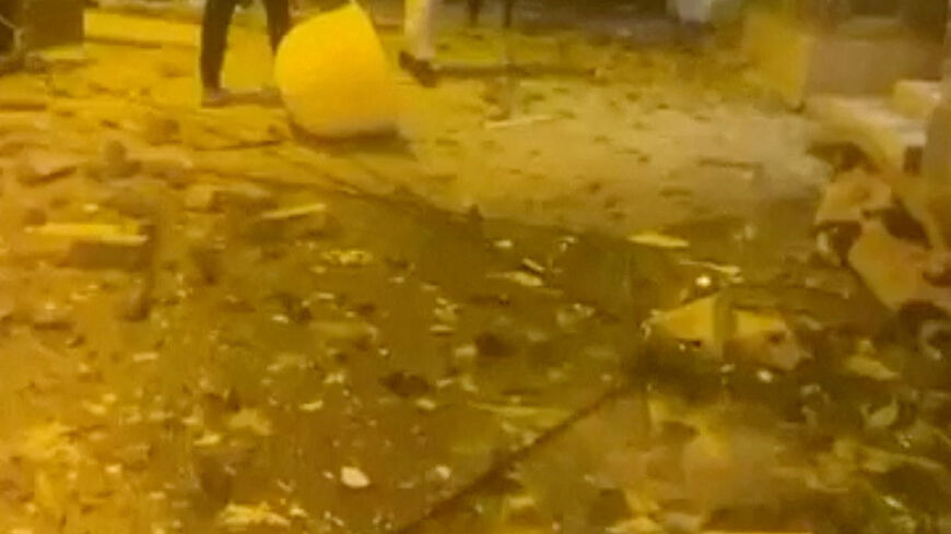 Debris lies on the street following reported Iranian drone strikes, amid the U.S.-Israeli conflict with Iran, in Sitra, Bahrain, March 9, 2026 in this screengrab taken from a social media video. SOCIAL MEDIA/via REUTERS