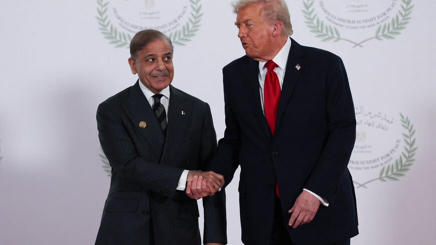 U.S. President Donald Trump and Pakistani Prime Minister Shehbaz Sharif shake hands as they pose for a photo, at a world leaders' summit on ending the Gaza war, amid a U.S.-brokered prisoner-hostage swap and ceasefire deal between Israel and Hamas, in Sharm el-Sheikh, Egypt, October 13, 2025. REUTERS/Suzanne Plunkett/Pool