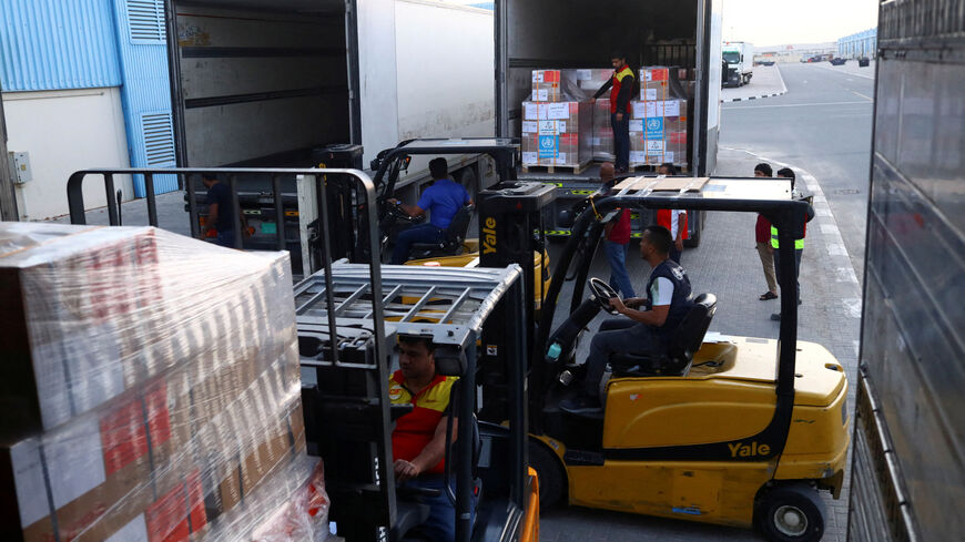 A World Health Organization (WHO) employees load trucks with humanitarian relief boxes ahead of flights sponsored by the International Humanitarian City (IHC) to Turkey and Syria which were devastated by an earthquake, in Dubai, United Arab Emirates, February 7, 2023. REUTERS/Amr Alfiky