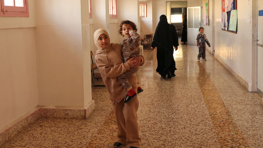 Displaced children walk at the Jaafareya High School, now used as a temporary shelter for displaced people, amid escalating hostilities between Israel and Hezbollah, as the U.S.-Israel conflict with Iran continues, in Beirut, Lebanon, March 27, 2026. REUTERS/Yara Nardi