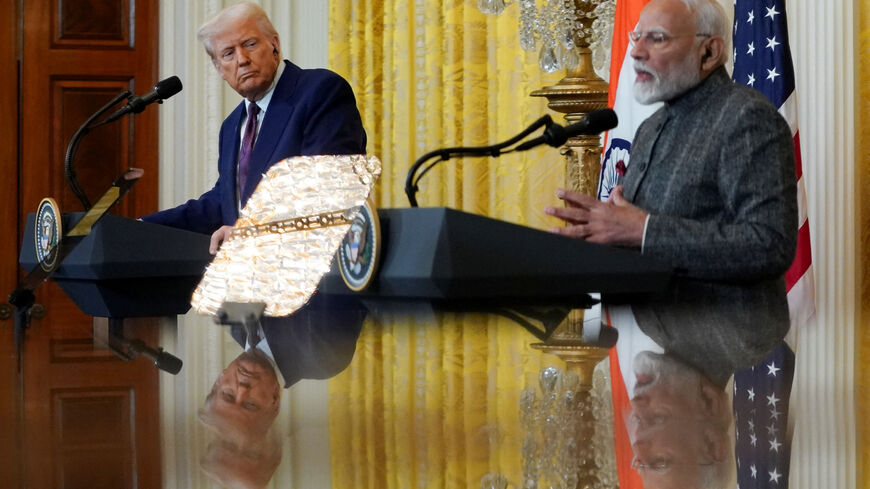 FILE PHOTO: U.S. President Donald Trump and Indian Prime Minister Narendra Modi are pictured in a mirror as they attend a joint press conference at the White House in Washington, D.C., U.S., February 13, 2025. REUTERS/Nathan Howard/File Photo