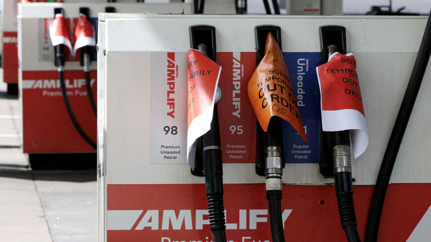 FILE PHOTO: 'Out of order' signs are displayed on empty fuel pumps at an Ampol petrol station after it ran out of fuel in Sydney, Australia, March 20, 2026. REUTERS/Hollie Adams/File Photo