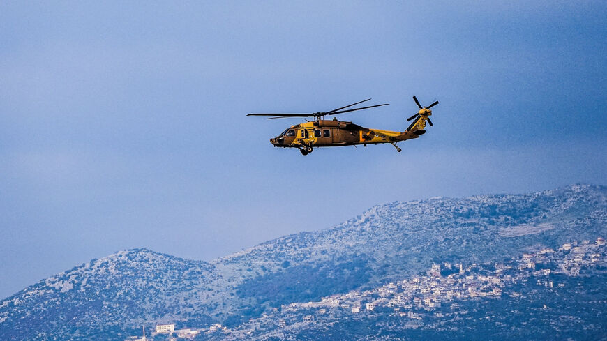 An Israeli military helicopter flies above the border between Israel and Lebanon, amid escalating hostilities between Israel and Hezbollah, as the U.S.-Israeli conflict with Iran continues, in northern Israel, March 28, 2026. REUTERS/Ayal Margolin       ISRAEL OUT. NO COMMERCIAL OR EDITORIAL SALES IN ISRAEL