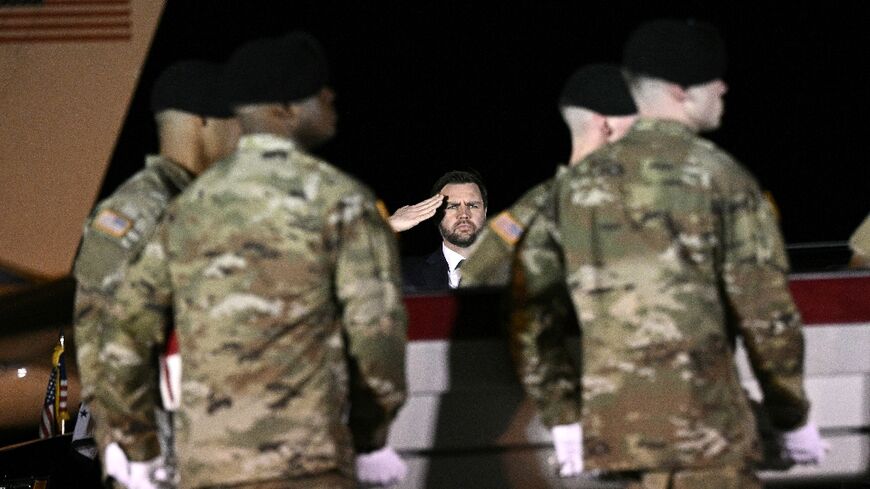 US Vice President JD Vance salutes as members of a US Army team carry a flagged-drapped transfer case containing the remains of Sgt. Benjamin N. Pennington, 26 during a dignified transfer event at Dover Air Force Base
