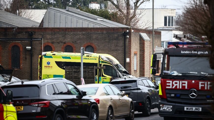 A damaged and burnt-out ambulance is pictured along a street in Golders Green, north London 