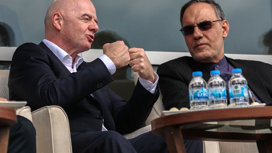 FIFA's President Gianni Infantino (L) makes a point as he watches Iran beat Costa Rica in Antalya, Turkey