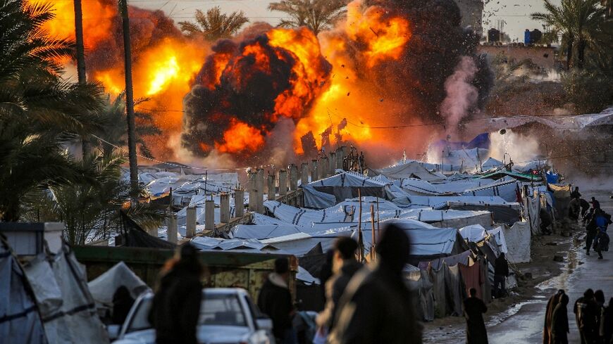 A fireball following an Israeli strike near a camp sheltering people displaced by war in Deir el-Balah, central Gaza 