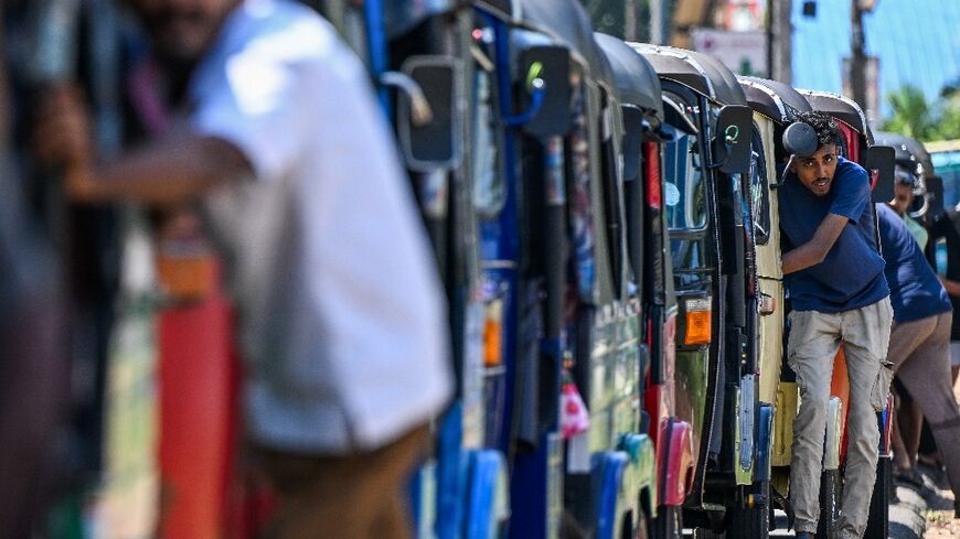 Drivers queue to refuel rickshaws at a fuel station on the outskirts of the Sri Lankan capital, as the war's economic impact mounts worldwide