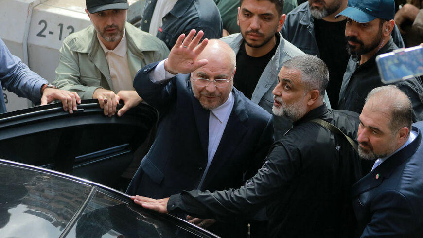 Iran's Parliament Speaker Mohammad Bagher Ghalibaf (C) waves as he returns to his car after visiting the site of an Israeli airstrike that targeted Beirut's Basta neighbourhood, on October 12, 2024. At least 22 people were killed in Israeli strikes on a densely populated area of central Beirut on October 10, the Lebanese health ministry said, with a security source saying a Hezbollah figure was the target. (Photo by Ibrahim AMRO / AFP) (Photo by IBRAHIM AMRO/AFP via Getty Images)