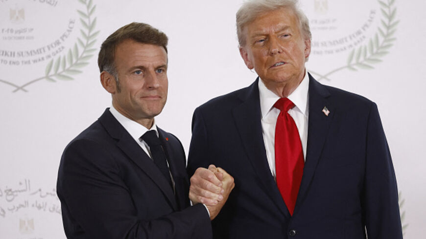 French President Emmanuel Macron (L) and US President Donald Trump (R) shake hands during the greetings ceremony at the Gaza Peace Summit in Sharm El-Sheikh, on October 13, 2025. (YOAN VALAT/AFP via Getty Images)