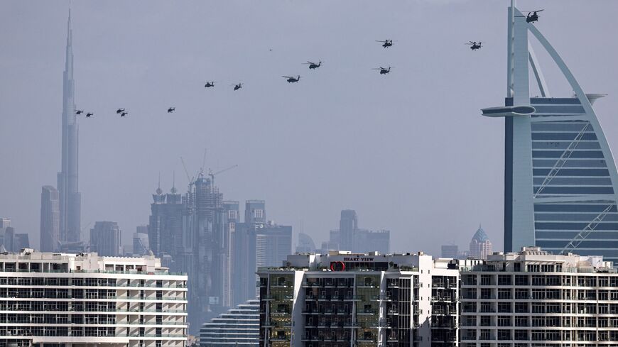 United Arab Emirates army helicopters fly from the Burj al Arab hotel (R) toward Burj Khalifa, Dubai, Jan. 16, 2026.