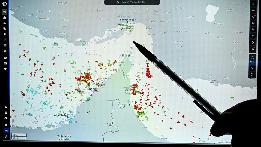 A person points at a page on the Marinetraffic website that shows commercial boats traffic on the edge of the Strait of Hormuz near the Iranian coast, in Paris on March 4, 2026. (Photo by JULIEN DE ROSA / AFP via Getty Images)