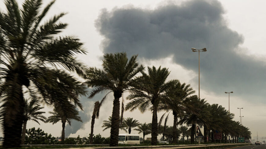 A plume of smoke rises after a reported Iranian strike on fuel tanks in Muharraq on March 12, 2026. (Fadhel MADHAN / AFP via Getty Images)