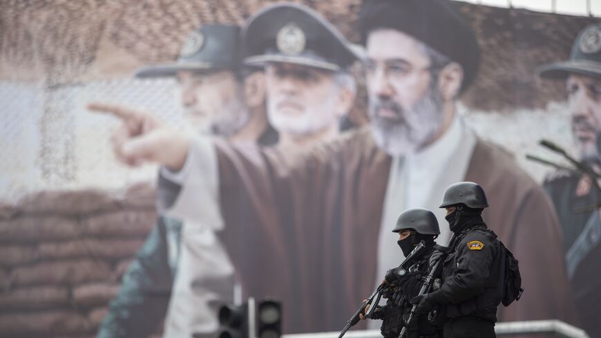  A billboard shows a graphic depicting Iranian Supreme Leader Ayatollah Mojtaba Khamenei with military commanders, as people attend the annual anti-Israeli Quds Day on March 13, 2026, in Tehran, Iran. 