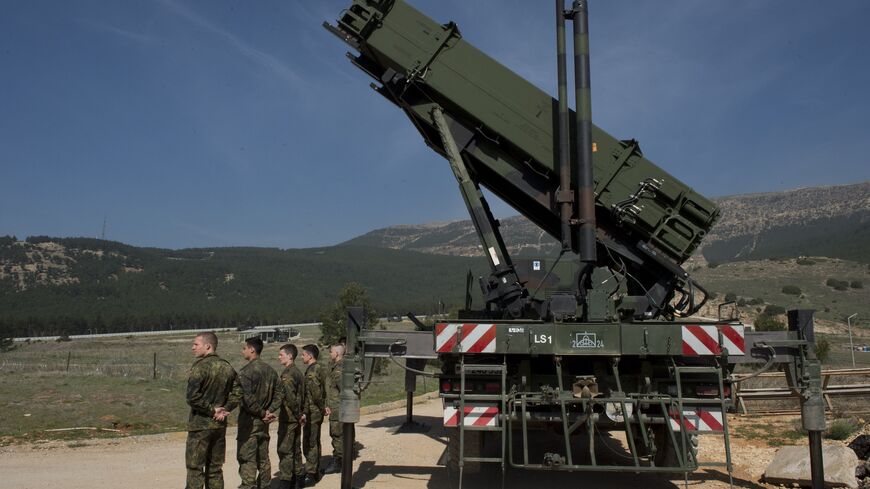 German soldiers stand to attention in front of a German Patriot missile launcher at the Gazi barracks in Kahramanmaras, southern Turkey on March 25, 2014. 