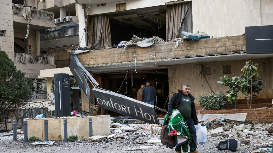 A man leaves the Comfort Hotel in Lebanon after it was hit by an air strike