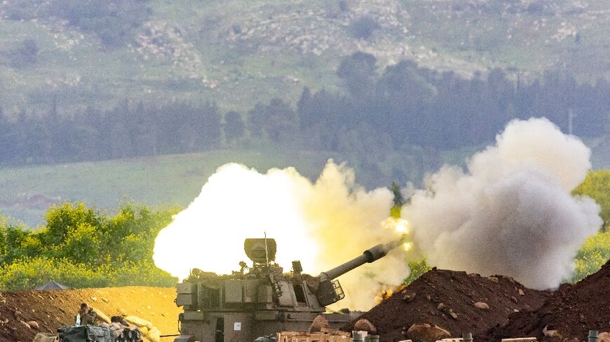 An Israeli self-propelled howitzer artillery gun fires rounds toward southern Lebanon