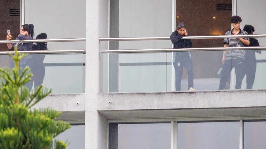 Members of the Iranian women’s football team are seen on their respective room balconies at the Royal Pines Resort on the Gold Coast on March 9, 2026