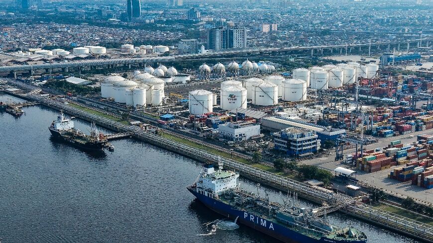 Tankers and cargo ships at the oil depot and container terminal of the Tanjung Priok Port in Jakarta