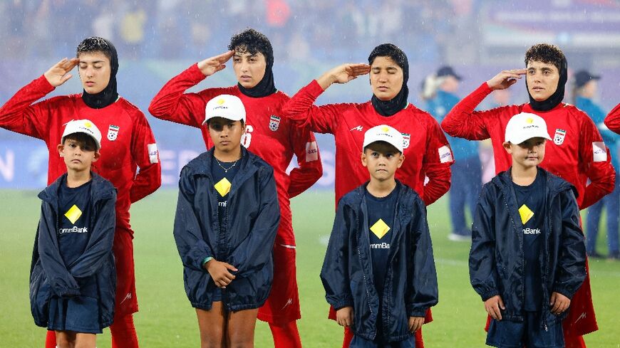 Iran's players salute during the national anthem before the AFC Women's Asian Cup Australia 2026 football match between Iran and Philippines in Gold Coast on March 8, 2026