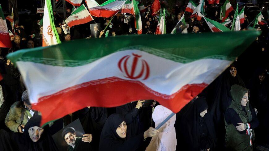 Iranians waved national flags and portraits of supreme leader Mojtaba Khamenei as they march in support of the country's armed forces in the capital Tehran