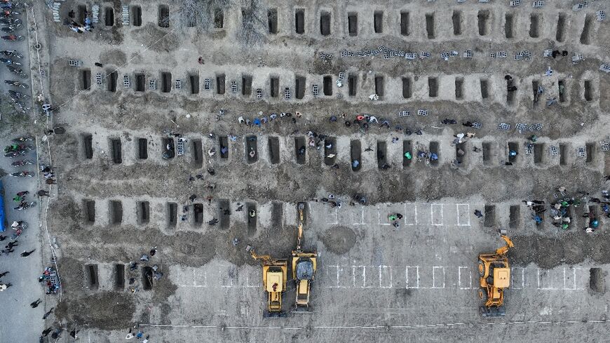 Graves are dug for children reportedly killed in a school strike in Minab, an image from the Iranian Press Center shows 
