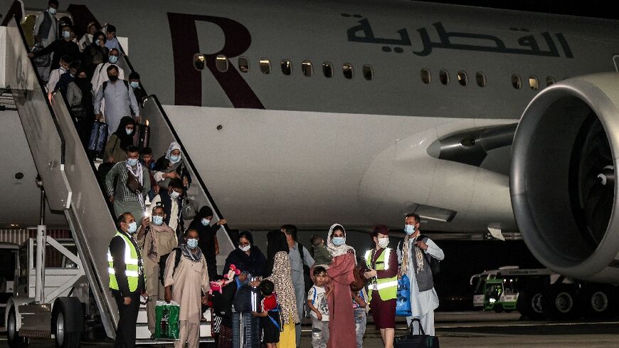 After the US withdrawal in 2021, evacuees from Afghanistan fled to escape the Taliban, seen here landing at Hamad International Airport in Qatar's capital Doha from Kabul 