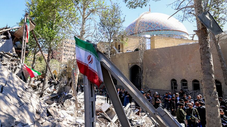 Journalists film outside a damaged mosque following strikes on Sharif University of Technology in Tehran on April 7, 2026