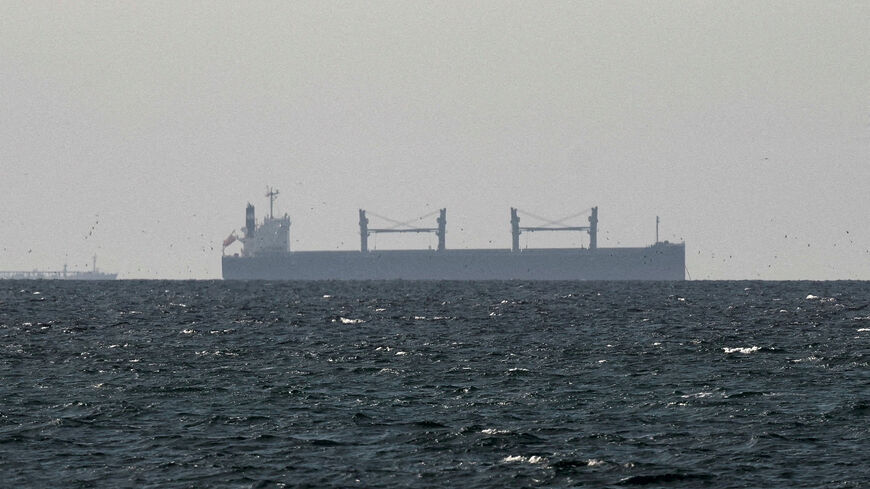 FILE PHOTO: A cargo ship in the Gulf, near the Strait of Hormuz, as seen from northern Ras al-Khaimah, near the border with Oman’s Musandam governance, amid the U.S.-Israeli conflict with Iran, in United Arab Emirates, March 11, 2026. REUTERS/Stringer/File Photo
