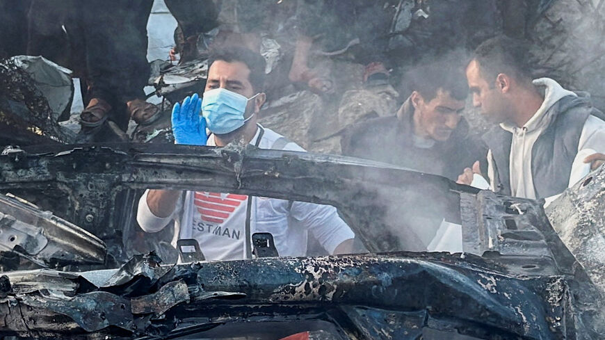 Palestinians inspect the site of what medics said was an Israeli airstrike on a car near the entrance to Zawayda town, amid the U.S.-Israeli conflict with Iran, in the central Gaza Strip, April 4, 2026. Picture taken with a mobile phone. REUTERS/Stringer