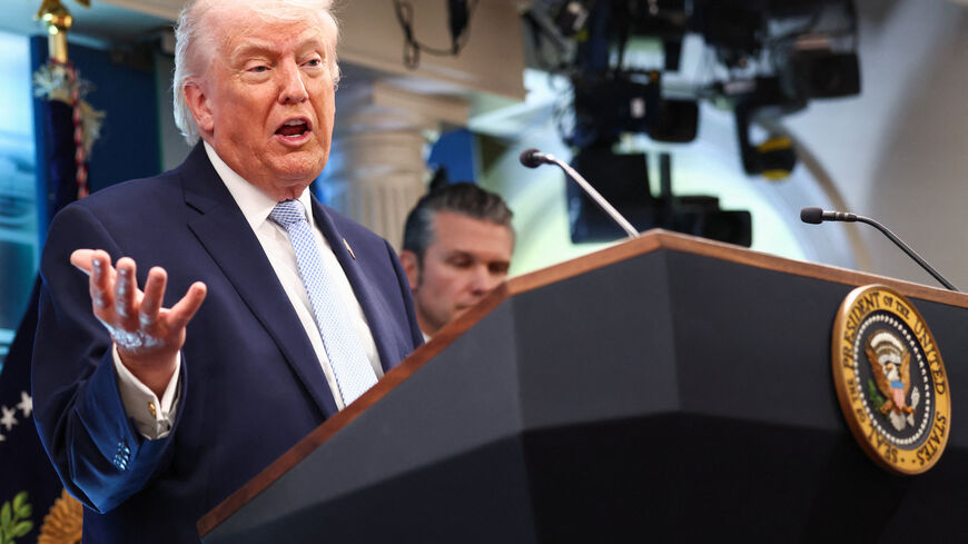 U.S. President Donald Trump, flanked by Secretary of Defense Pete Hegseth, speaks during a press conference in the James S. Brady Press Briefing Room at the White House in Washington, D.C., U.S., April 6, 2026. REUTERS/Kevin Lamarque