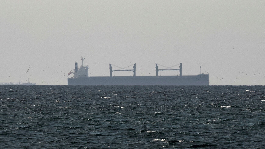 FILE PHOTO: A cargo ship in the Gulf, near the Strait of Hormuz, as seen from northern Ras al-Khaimah, near the border with Oman’s Musandam governance, amid the U.S.-Israeli conflict with Iran, in United Arab Emirates, March 11, 2026. REUTERS/Stringer/File Photo
