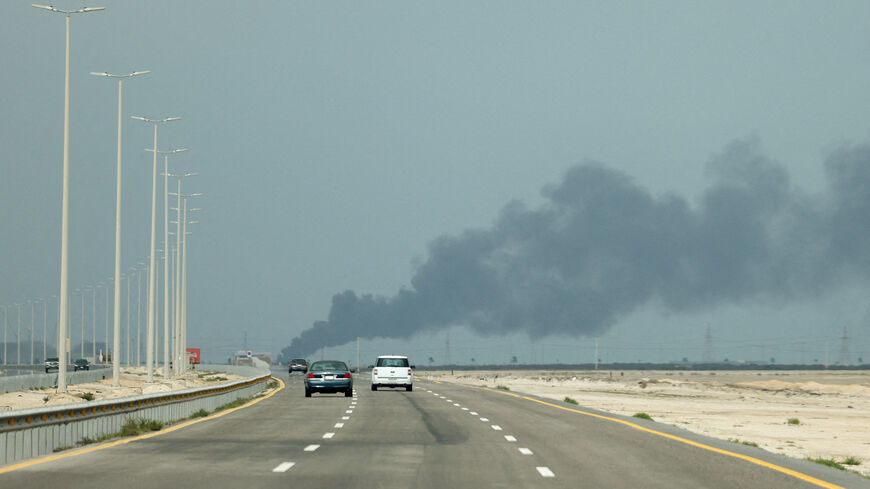 FILE PHOTO: Vehicles move along a road as smoke billows from Saudi Aramco's Ras Tanura oil refinery after a reported Iranian drone strike, amid the U.S.-Israel conflict with Iran, in Ras Tanura, Saudi Arabia, March 2, 2026. REUTERS/Stringer/File Photo