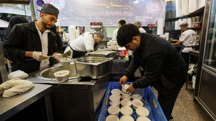 Workers prepare food at a restaurant, amid heightened tensions linked to the U.S.-Israeli conflict with Iran, in Tehran, Iran, March 13, 2026. REUTERS/Alaa Al Marjani