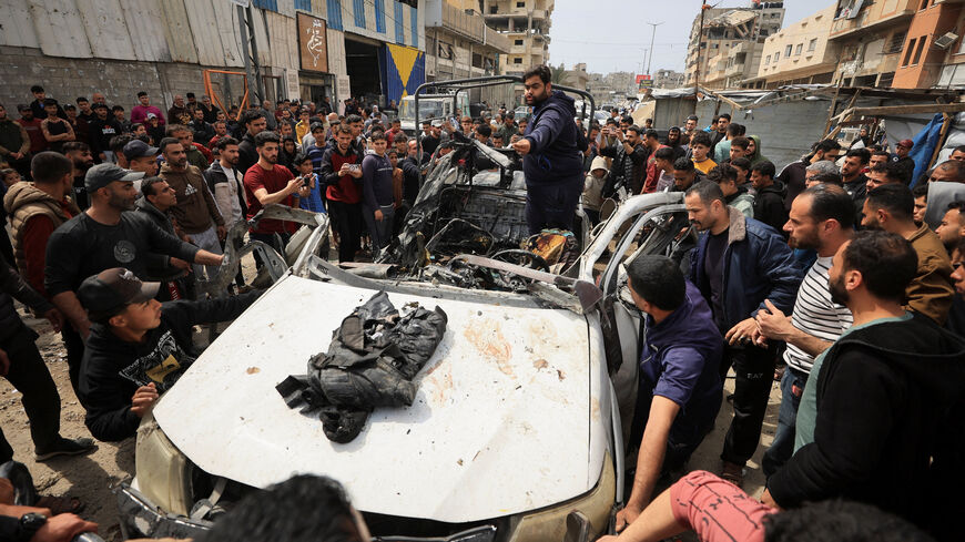 Palestinians inspect the damage after an Israeli strike targeted a police vehicle in Gaza City, according to medics, in Gaza City, April 14, 2026. REUTERS/Dawoud Abu Alkas
