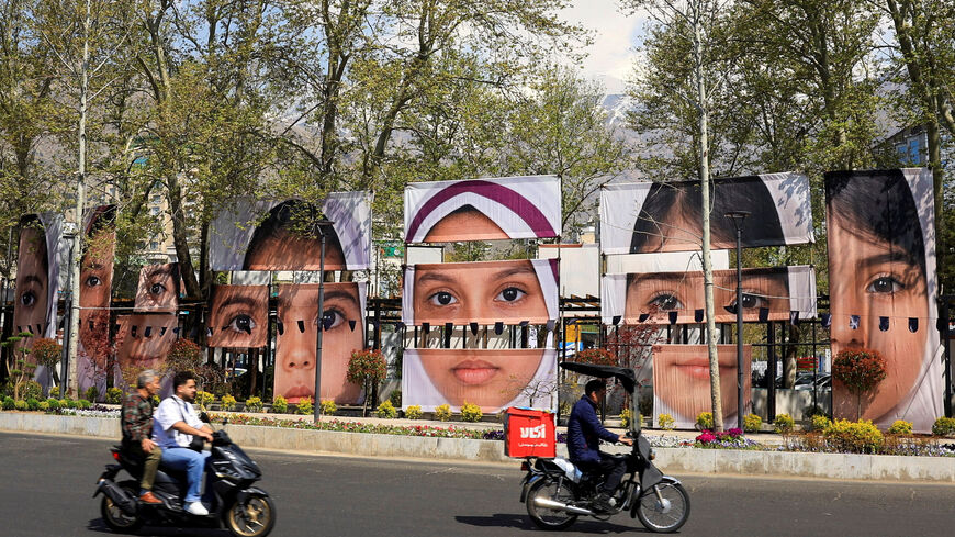 People on motorcycles ride along a street past banners showing portraits of students killed in a strike on a girls’ school during the U.S.-Israeli conflict with Iran, amid a ceasefire, at Tajrish Square in Tehran, Iran, April 15, 2026. REUTERS/Thaier Al-Sudani  Foreign media in Iran operate under guidelines set by the Ministry of Culture and Islamic Guidance, which regulates press activity and permissions.