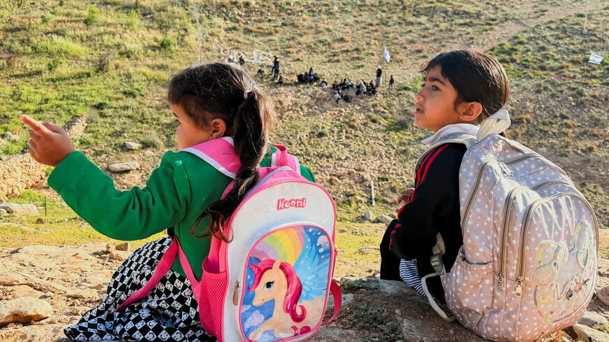 Palestinian students gather near a fence installed by Israeli settlers in their way to school, near Umm al-Khair village in Masafer Yatta, in the Israeli-occupied West Bank, April 14, 2026. Picture taken with a mobile phone. REUTERS/Yosri Aljamal