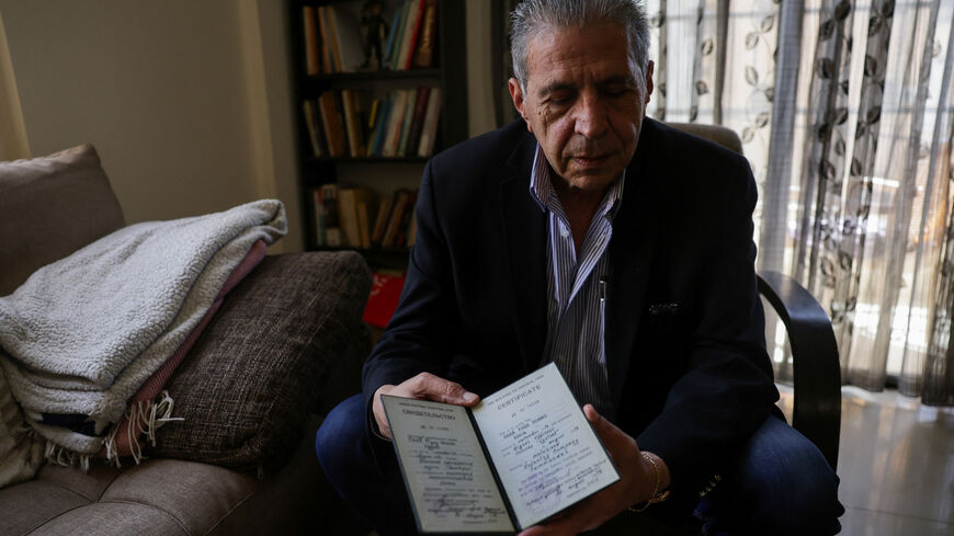 Head of the Lebanese NGO Fighters for Peace Ziad Saab shows a certificate he received from the Soviet Ministry of Defence after participating in military training in the Soviet Union during the Lebanese civil war, in his home in Beirut, Lebanon, April 14, 2026. REUTERS/Emilie Madi