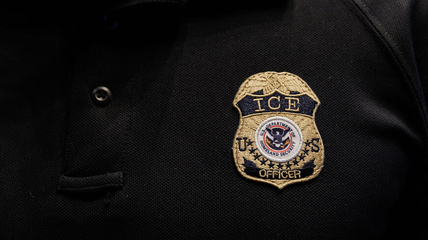 The badge of a U.S. Immigration and Customs Enforcement (ICE) is embroidered on a polo shirt of an ICE employee, at a U.S. Immigration and Customs Enforcement  two-day job fair in Texas to help fill vacancies for deportation officers and attorneys, in Arlington, Texas, U.S. August 26, 2025.  REUTERS/Shelby Tauber
