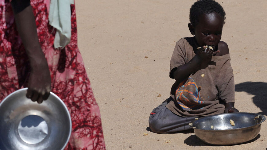 FILE PHOTO: A Sudanese orphaned child refugee from al-Fashir eats a free meal provided by the ?Group Kitchen Project? inside the Tine transit camp in eastern Chad, amid the conflict between the paramilitary Rapid Support Forces (RSF) and the Sudanese army, November 22, 2025. REUTERS/Amr Abdallah Dalsh/File Photo