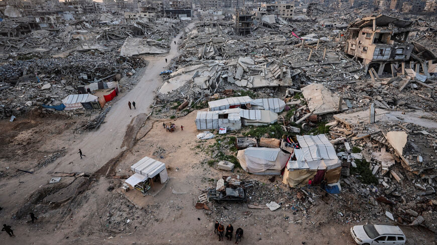 Palestinians gather near the rubble of residential buildings destroyed during the two-year Israeli offensive, on the first day of the holy month of Ramadan, in Gaza City, February 18, 2026. REUTERS/Dawoud Abu Alkas/File Photo