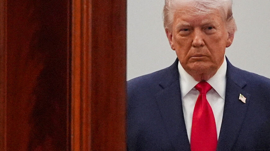 FILE PHOTO: President Donald Trump arrives from the Blue Room to speak about the Iran war from the Cross Hall of the White House on Wednesday, April 1, 2026, in Washington.     Alex Brandon/Pool via REUTERS/File Photo