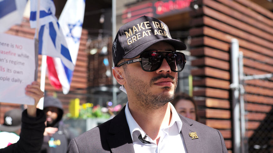 Ali Daneshfar, an operations coordinator with Cyrus the Great, a Toronto-based Iranian group, attends a rally in support of U.S. President Trump's military actions towards Iran, while expressing dissatisfaction with the current ceasefire, in Toronto, Ontario, Canada, April 26, 2026. REUTERS/Wa Lone