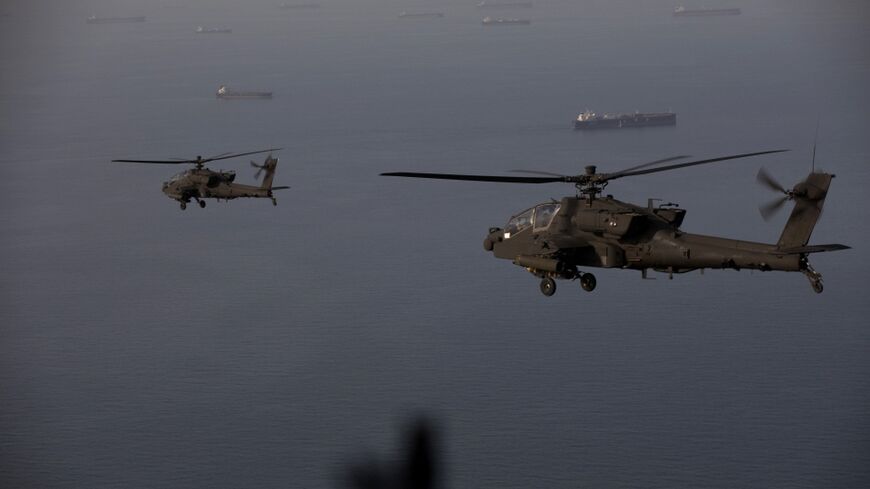 This handout photo released by US Central Command shows AH-64 Apaches flying above the Strait of Hormuz during a patrol on April 17, 2026