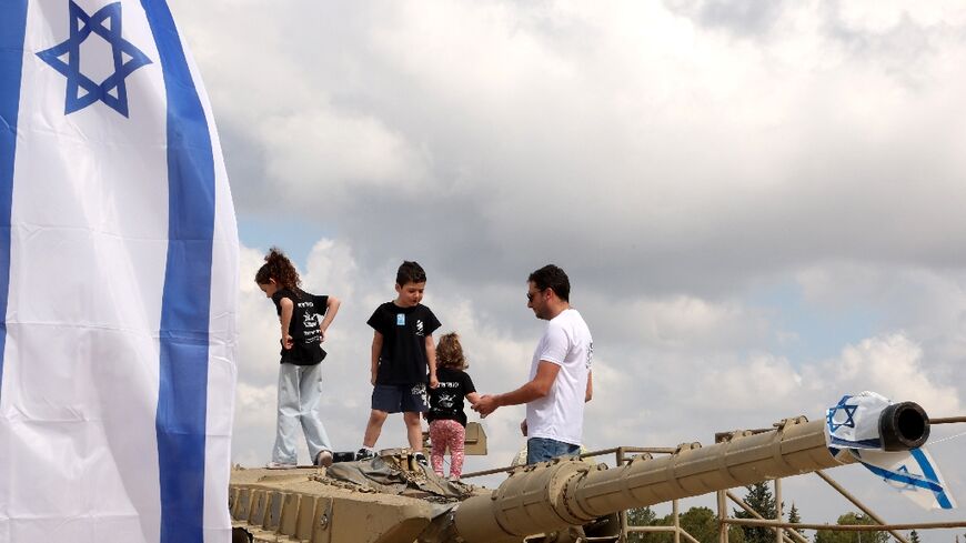 Children climb atop old tanks at the Israeli Armoured Corps memorial in Latrun, between Jerusalem and Tel Aviv