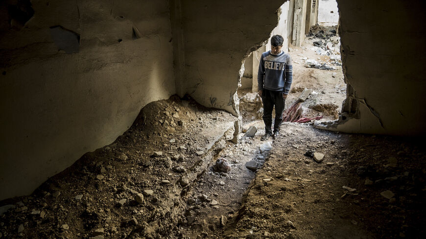 A young man stands in the entrance of tunnels that were used by the ISIS and the Assad's regime for fighting. Tadamon, Syria, February 7, 2025. (Photo by Raghed Waked / Middle East Images / Middle East Images via AFP) (Photo by RAGHED WAKED/Middle East Images/AFP via Getty Images)
