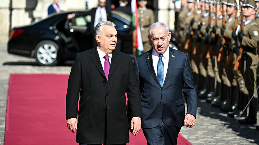 Hungary's Prime Minister Viktor Orban (L) and Israeli Prime Minister Benjamin Netanyahu review a military honor guard on April 3, 2025 in Budapest, Hungary. Israeli Prime Minister Benjamin Netanyahu arrived in Hungary in defiance of the International Criminal Court (ICC)'s arrest warrant against him over alleged war crimes in Gaza. Hungary has long-standing ties with Israel, and they been further bolstered up since the start of the war in Gaza, sparked by the Palestinian militant group Hamas's attack on Oct