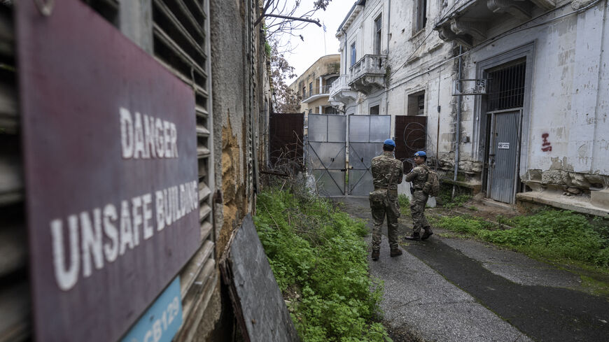 Members of the UN Peacekeeping Force in Cyprus (UNFICYP), from the British Army's 1st Battalion Coldstream Guards, No. 2 Company, patrol along the buffer zone separating the internationally recognized Republic of Cyprus and the breakaway Turkish Republic of Northern Cyprus in the divided capital Nicosia on Feb. 17, 2026. 